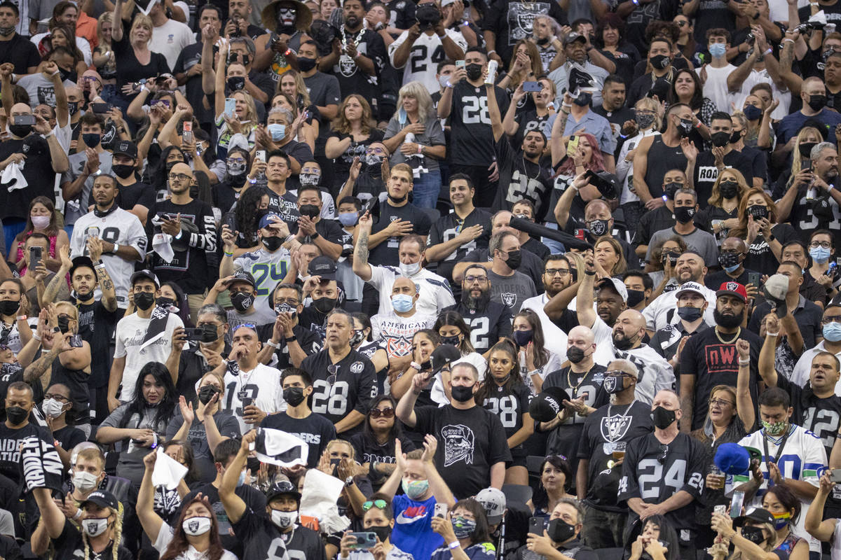 Fans celebrate the start of the Raiders home opening pre-season NFL football game versus the Se ...