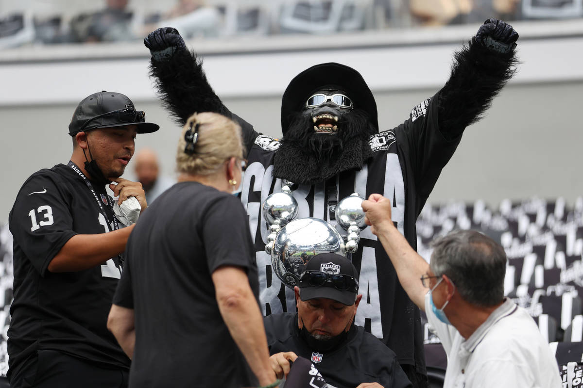 Gorilla Rilla raises his arms after making it inside of Allegiant Stadium before the start of a ...