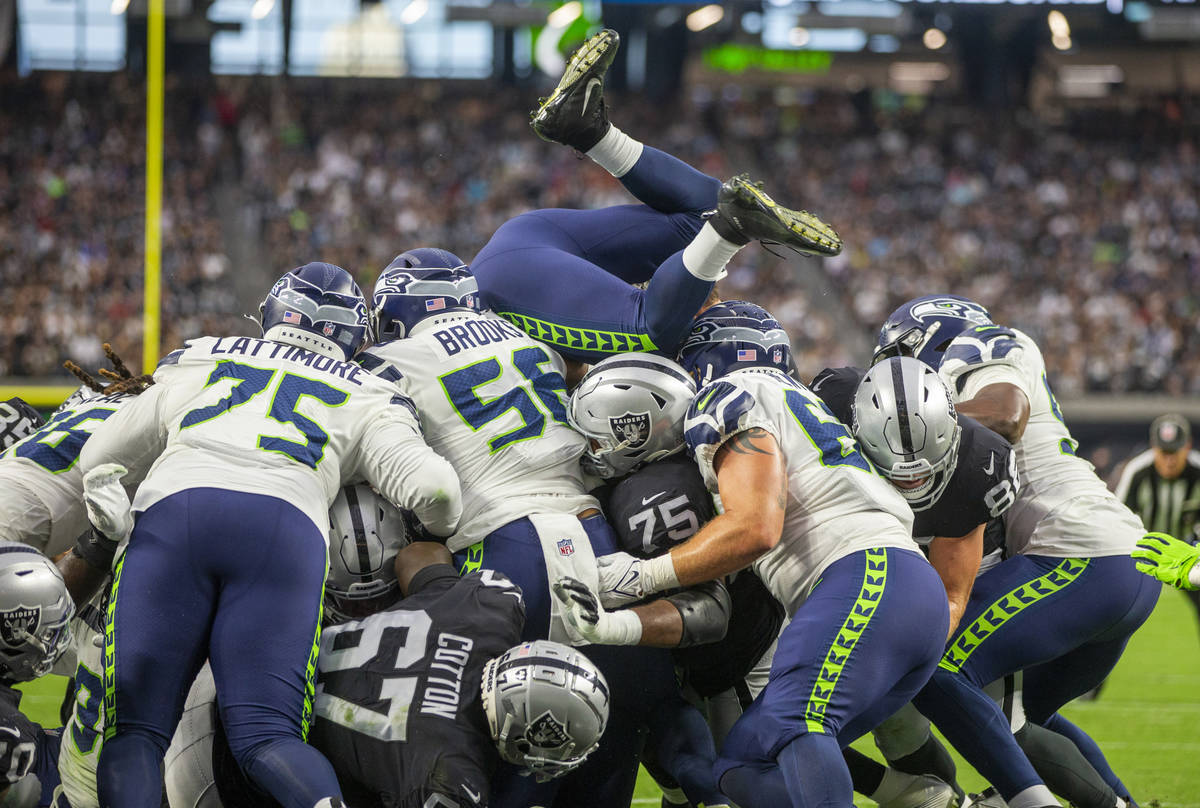 Players stack up on the goal line as the Raiders attempt to score during the first quarter of t ...