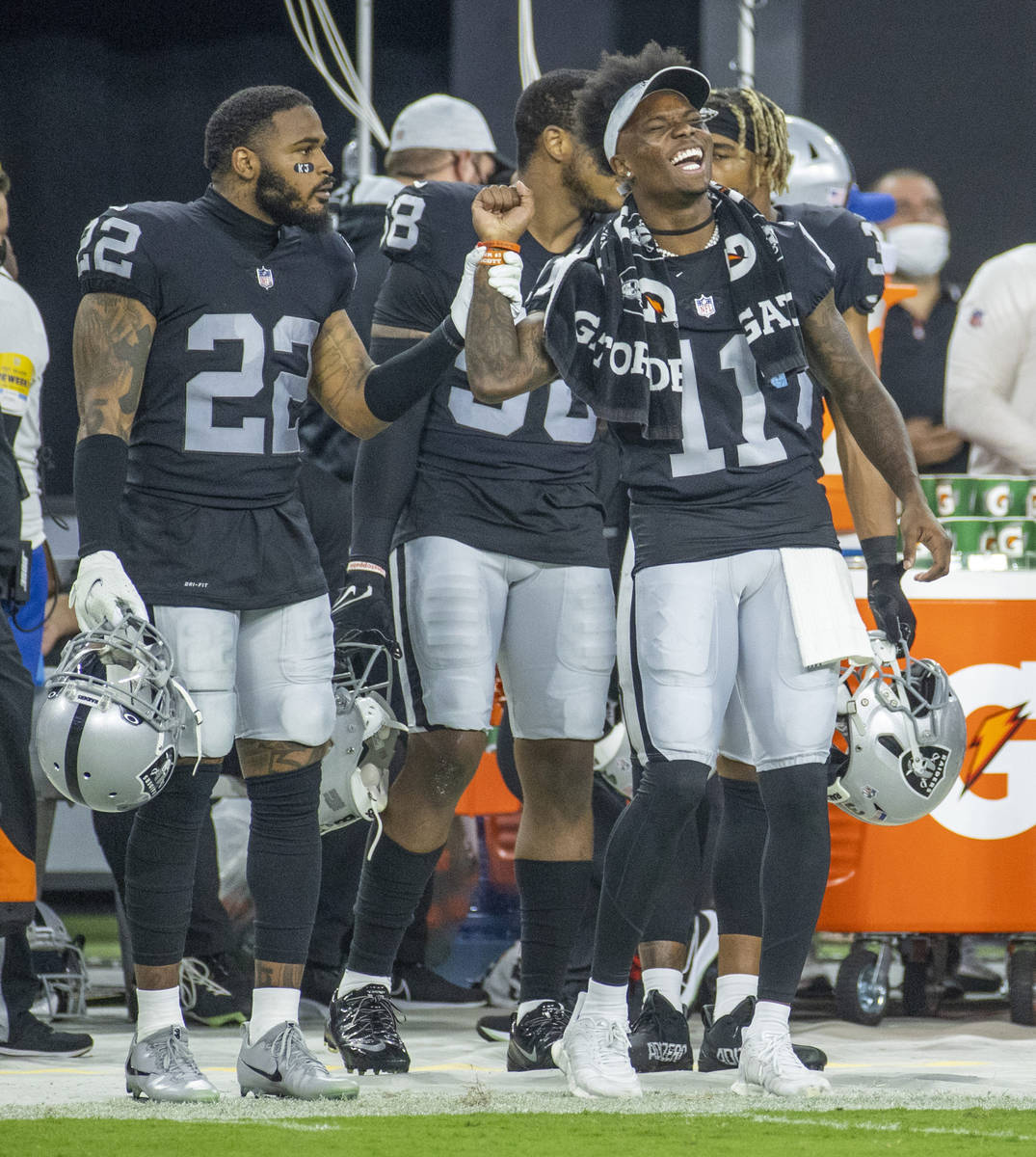 Raiders defensive back Keisean Nixon (22) and teammate wide receiver Henry Ruggs III (11) joke ...