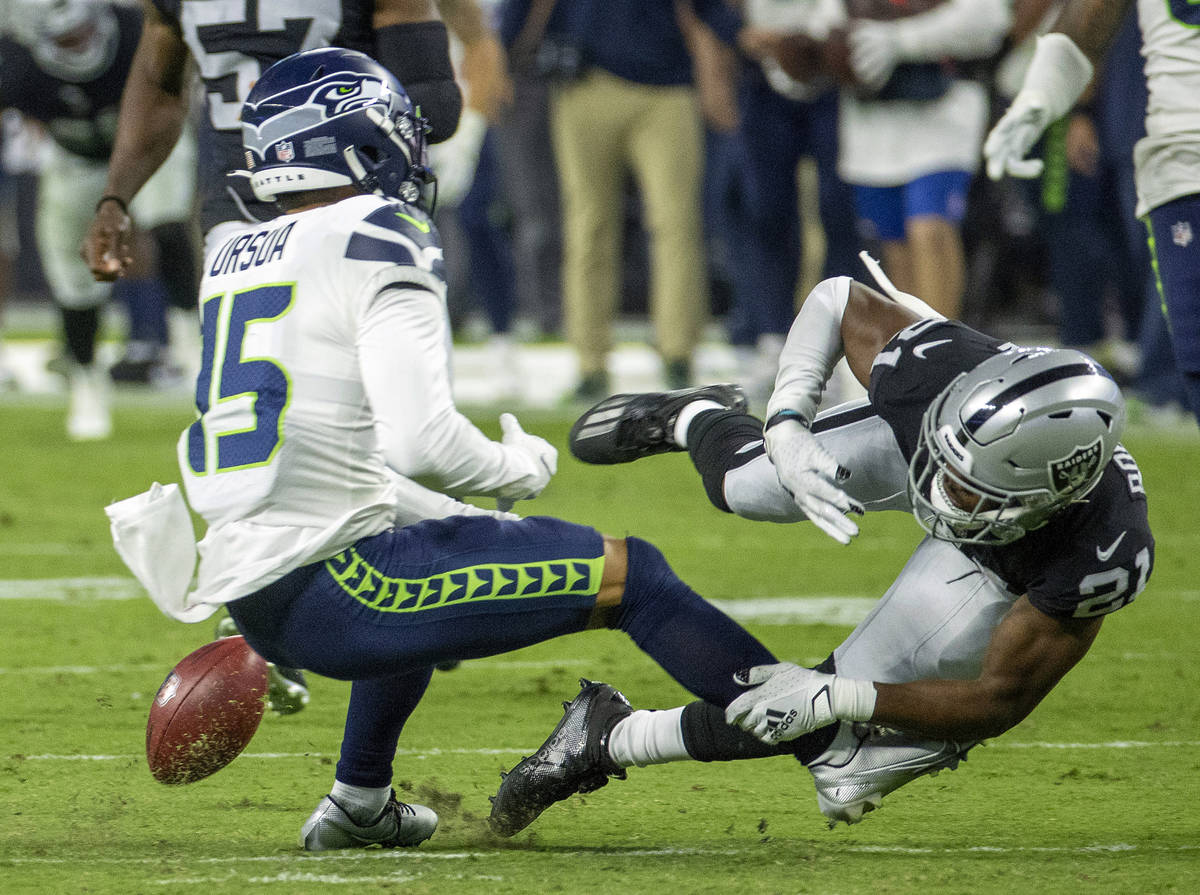 Seattle Seahawks wide receiver John Ursua (15) loses the ball on a kickoff reception after an e ...