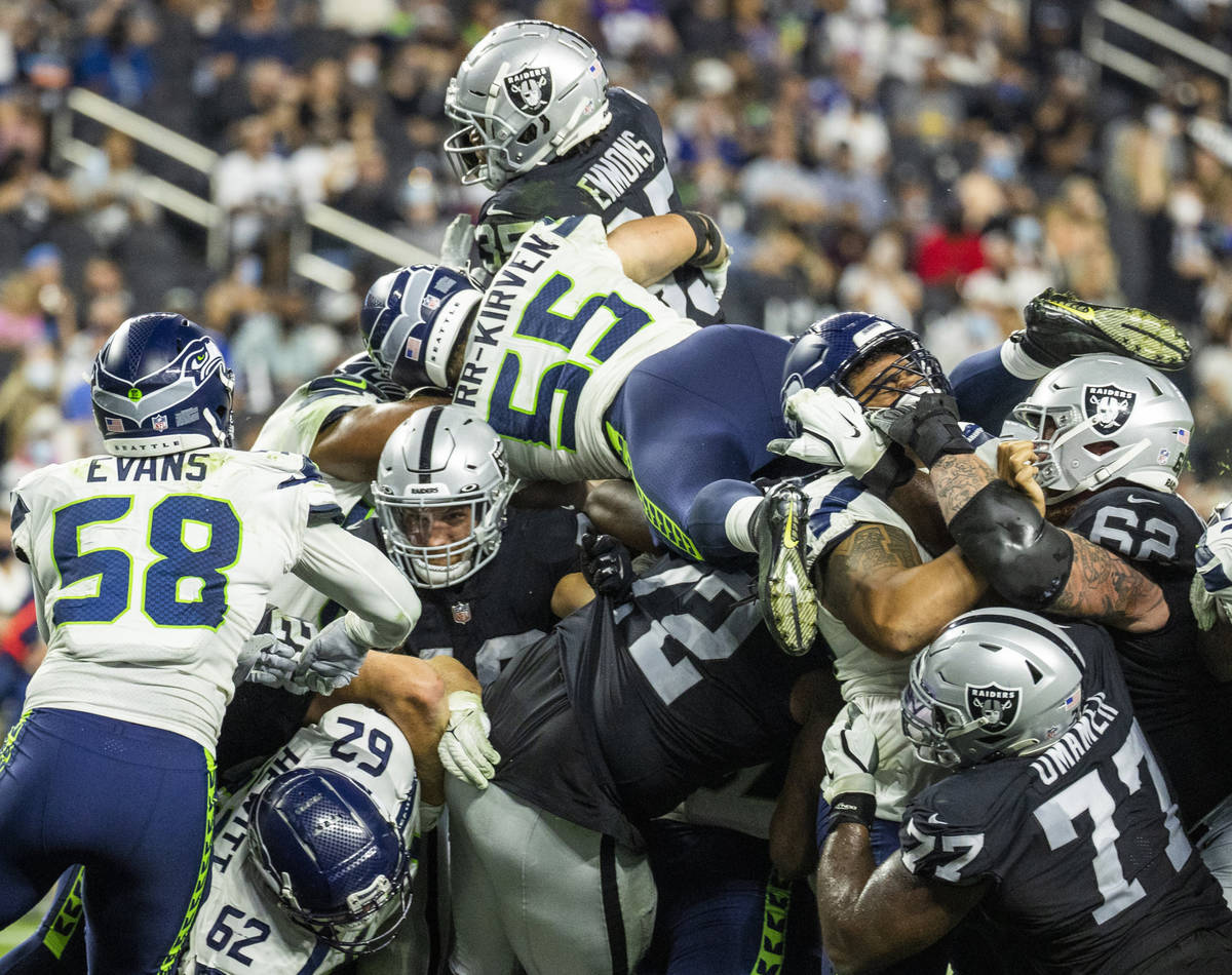 Raiders running back B.J. Emmons (35) goes up top and crosses the goal line as Seattle Seahawks ...