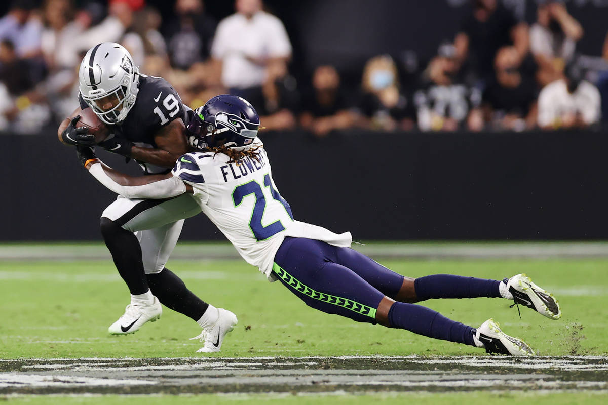 Las Vegas Raiders wide receiver DJ Turner (19) is tackled by Seattle Seahawks cornerback Tre Fl ...