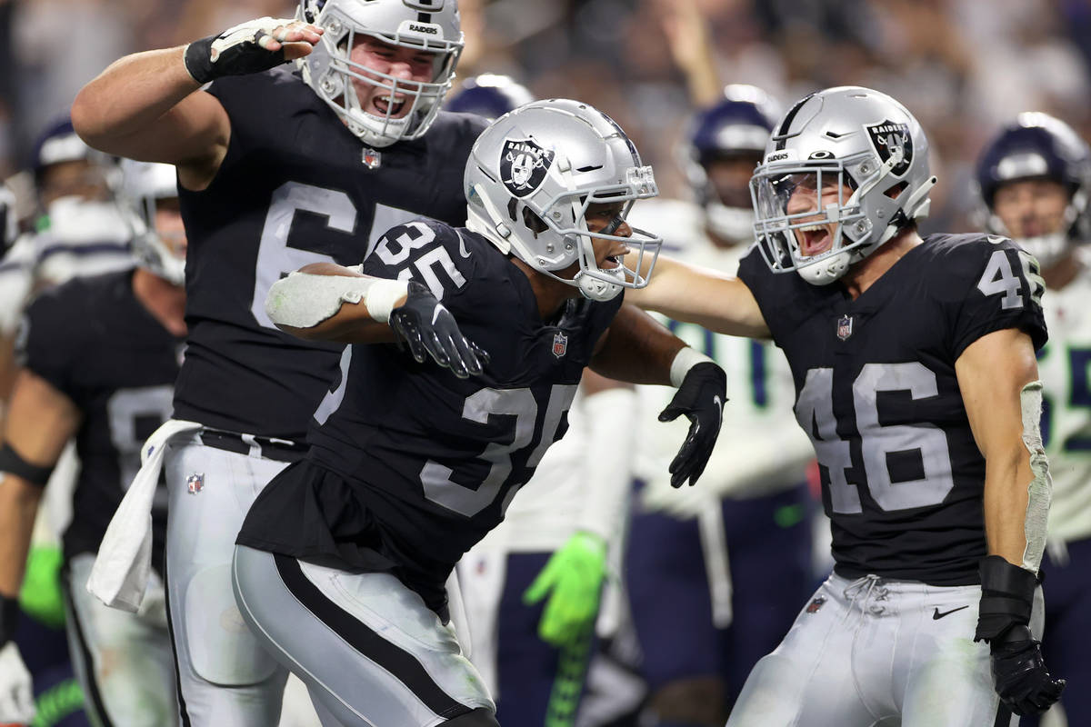 Las Vegas Raiders running back B.J. Emmons (35) celebrates a rushing touchdown, with center Jim ...