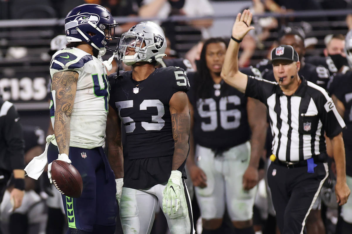 Seattle Seahawks tight end Dom Wood-Anderson and Las Vegas Raiders linebacker Javin White (53) ...