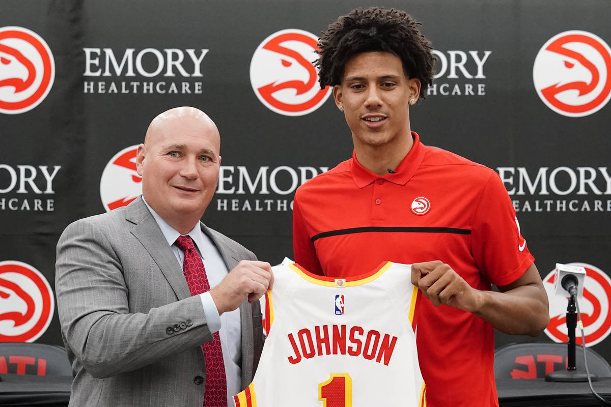 Atlanta Hawks NBA basketball draft pick Jalen Johnson, right, and Hawks general manger Travis S ...