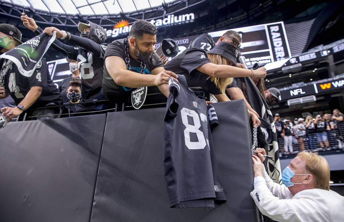 Raiders owner Mark Davis signs autographs for fans before the Raiders home opening pre-season N ...