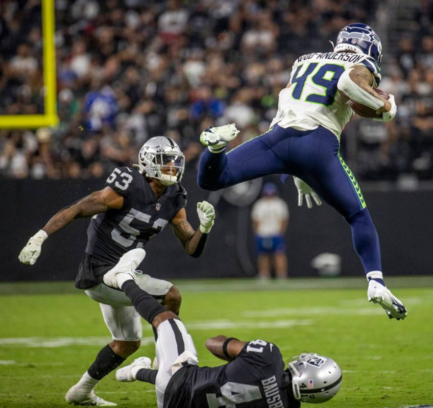 Seattle Seahawks tight end Dom Wood-Anderson (49) leaps over Raiders cornerback DeVante Bausby ...