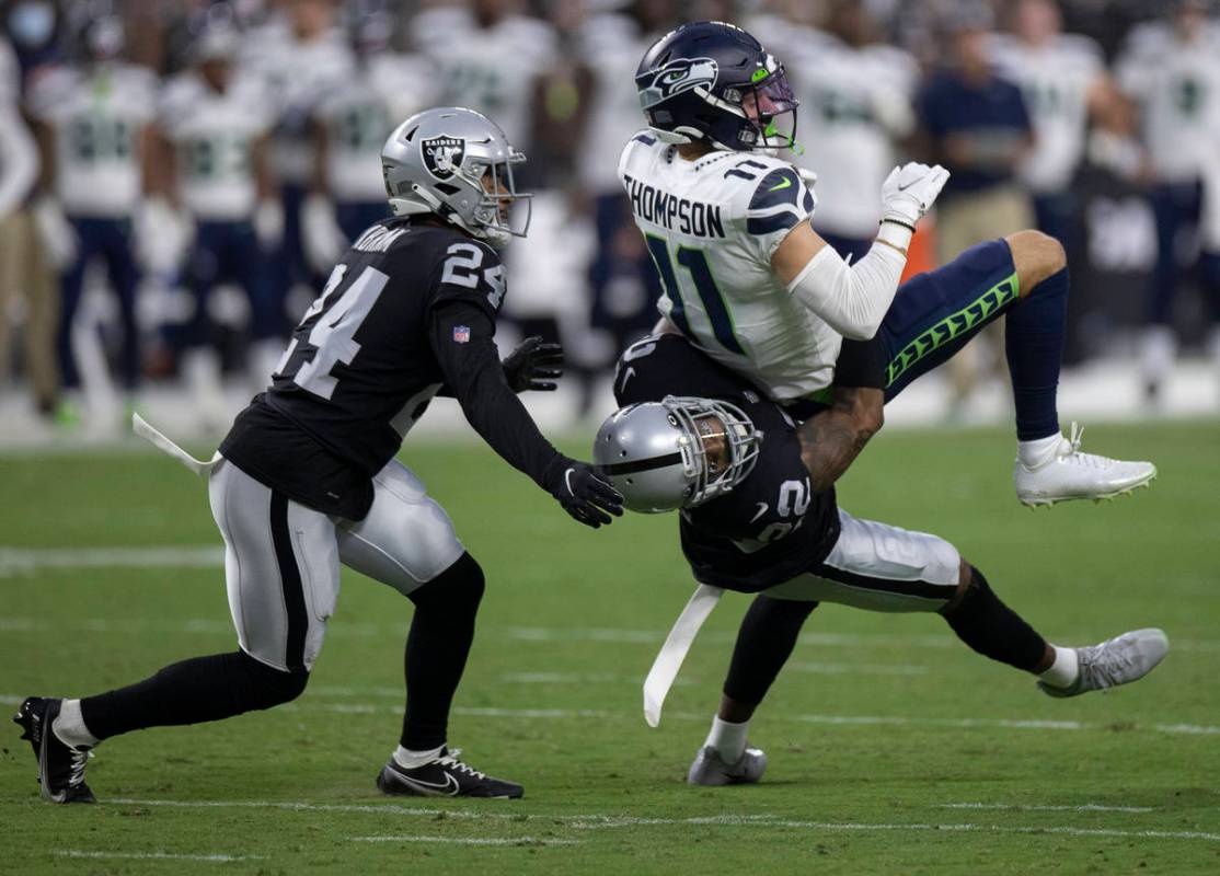 Raiders defensive back Keisean Nixon (22) tackles Seattle Seahawks wide receiver Cody Thompson ...