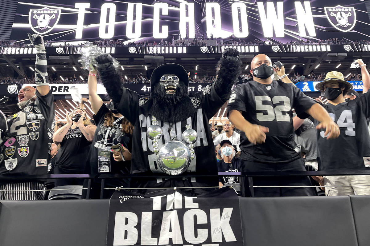 Fans, including Mark Acasio as Gorilla Rilla cheer a touchdown during the Raiders home opening ...