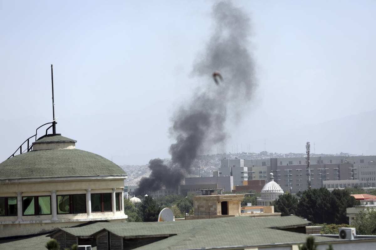 Smoke rises next to the U.S. Embassy in Kabul, Afghanistan, Sunday, Aug. 15, 2021. Taliban figh ...