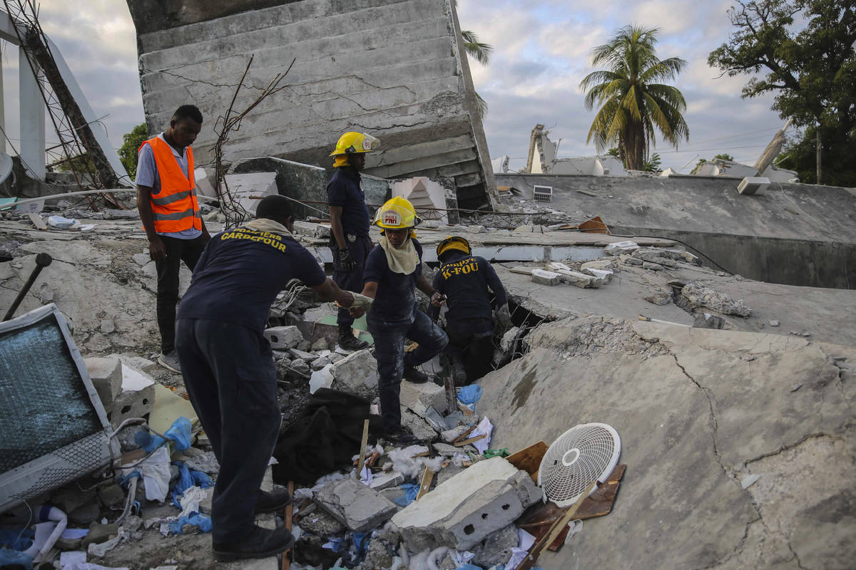 Firefighters search for survivors inside a collapsed building, after Saturday´s 7.2 magnit ...