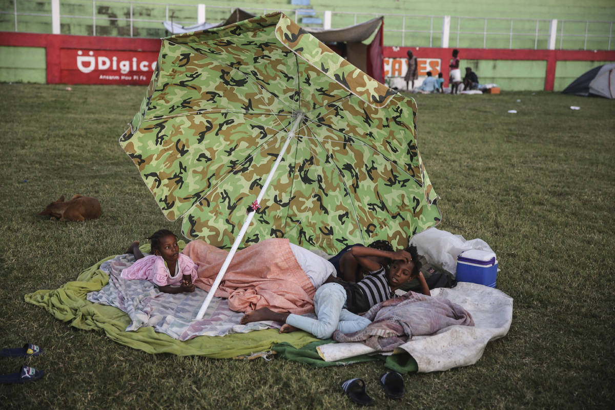 People rest after spending the night at a soccer field following Saturday´s 7.2 magnitude ...