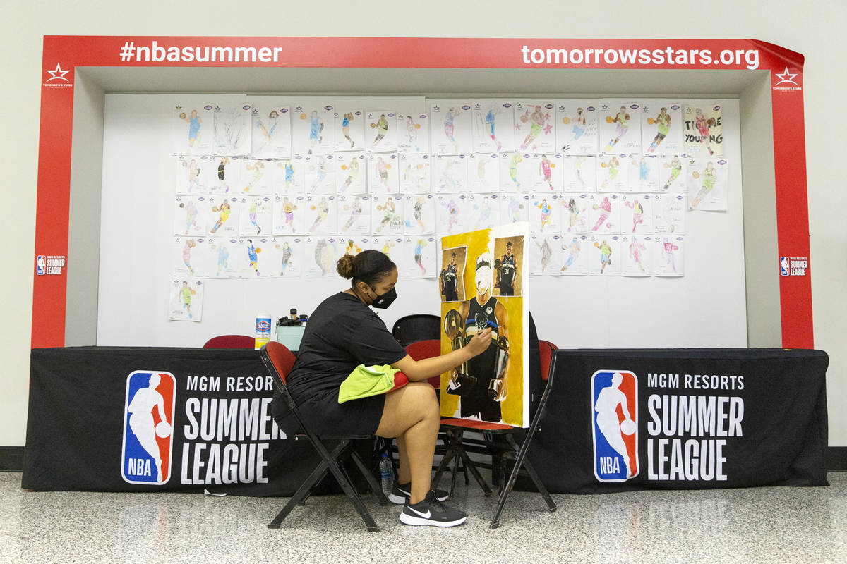 Keely Jackson, a NBA Summer League intern for the third year in a row, does a live painting of ...