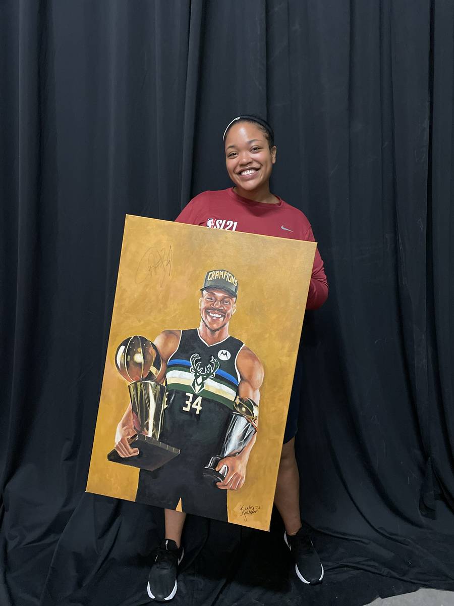 Keely Jackson poses for a photo with her portrait of Milwaukee Bucks forward and reigning NBA F ...