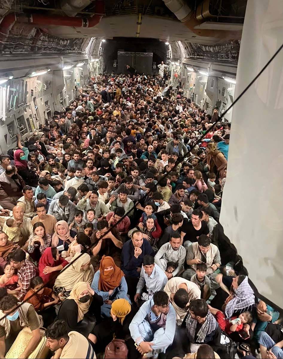 Afghan citizens pack inside a U.S. Air Force C-17 Globemaster III, as they are transported from ...