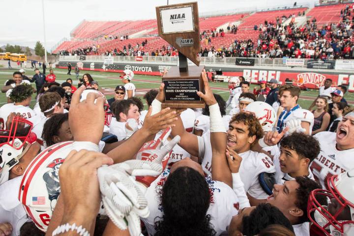 Liberty players celebrate after defeating Centennial 50-7 to win the Class 4A state football ch ...