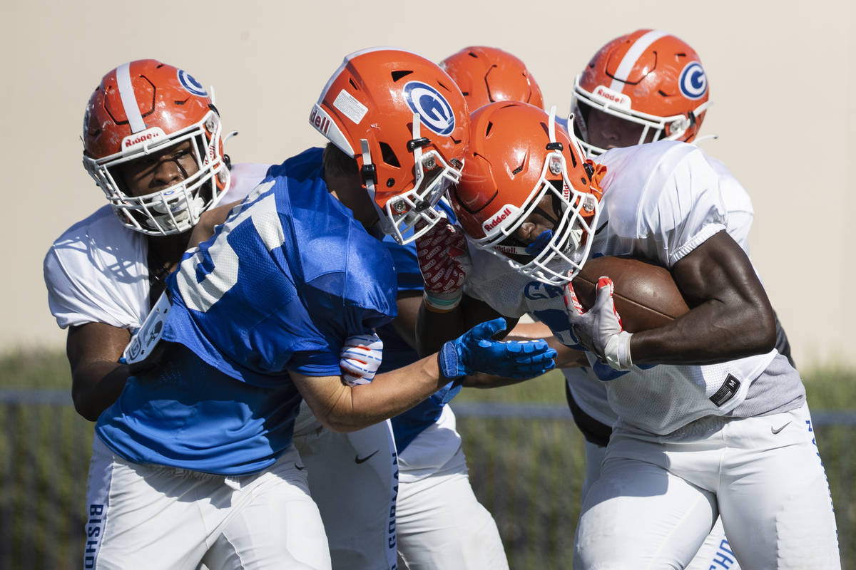 Bishop Gorman High SchoolÕs running back/linebacker Will Stallings, right, avoids a tackle ...