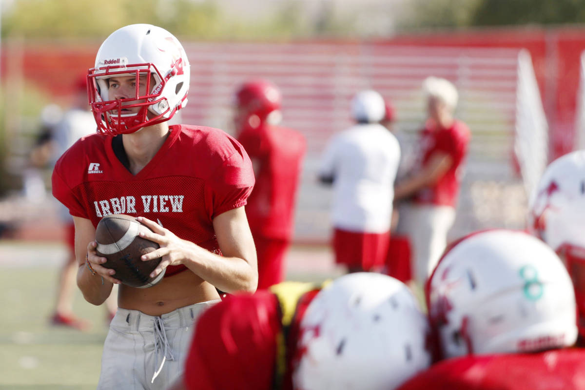 Arbor View's varsity quarterback Kyle Holmes (17), runs drills during practice at Arbor View Hi ...