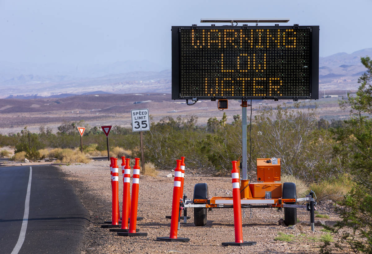 A sign warns about low water after the entrance to the Lake Mead National Recreation Area on Tu ...