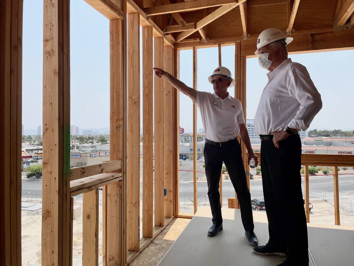 Robert Feibleman, executive vice president of construction for Nevada HAND, left, shows Nevada ...