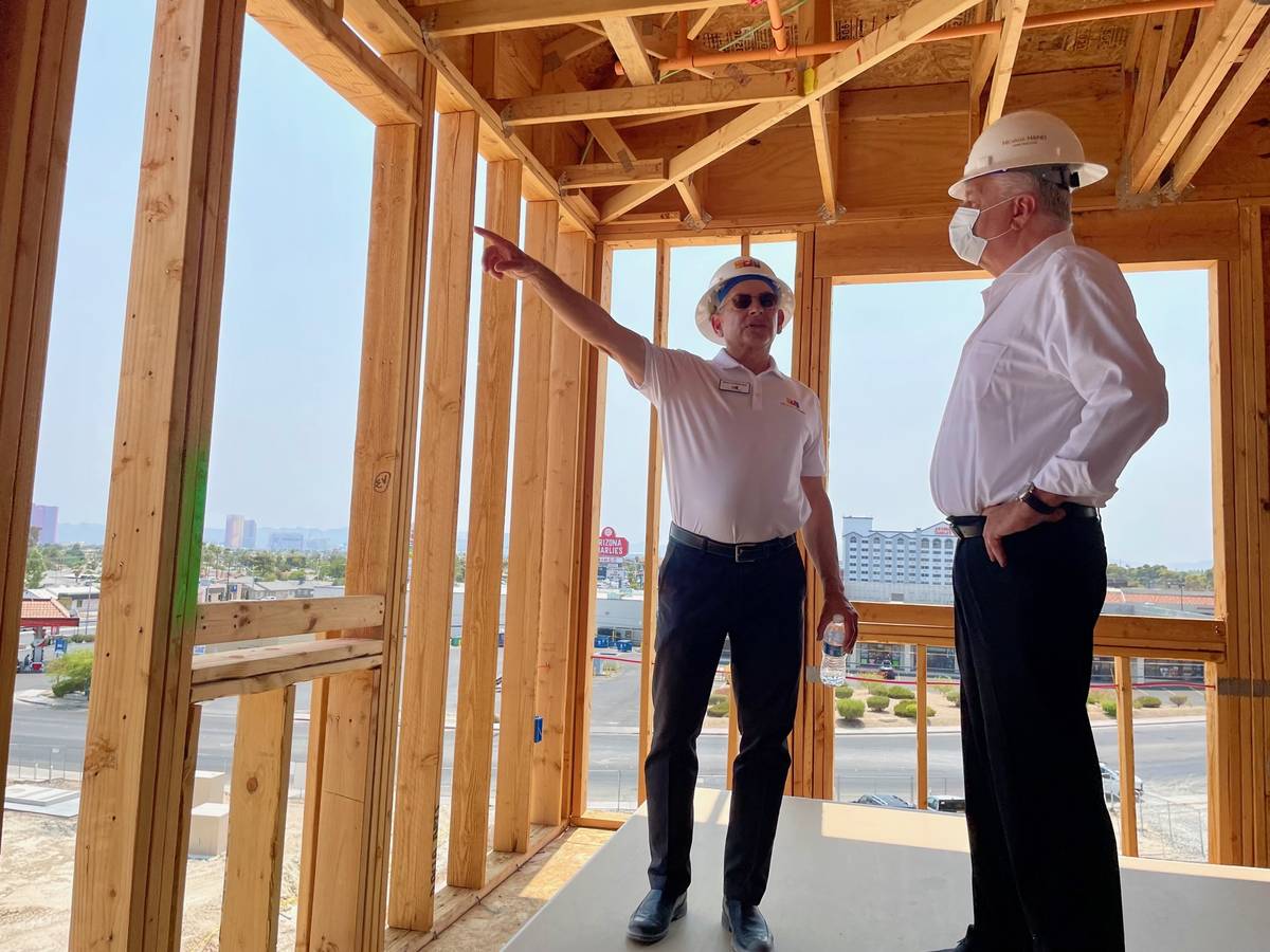 Robert Feibleman, executive vice president of construction for Nevada HAND, left, shows Nevada ...