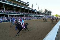 John Velazquez riding Medina Spirit leads Florent Geroux on Mandaloun, Flavien Prat riding Hot ...