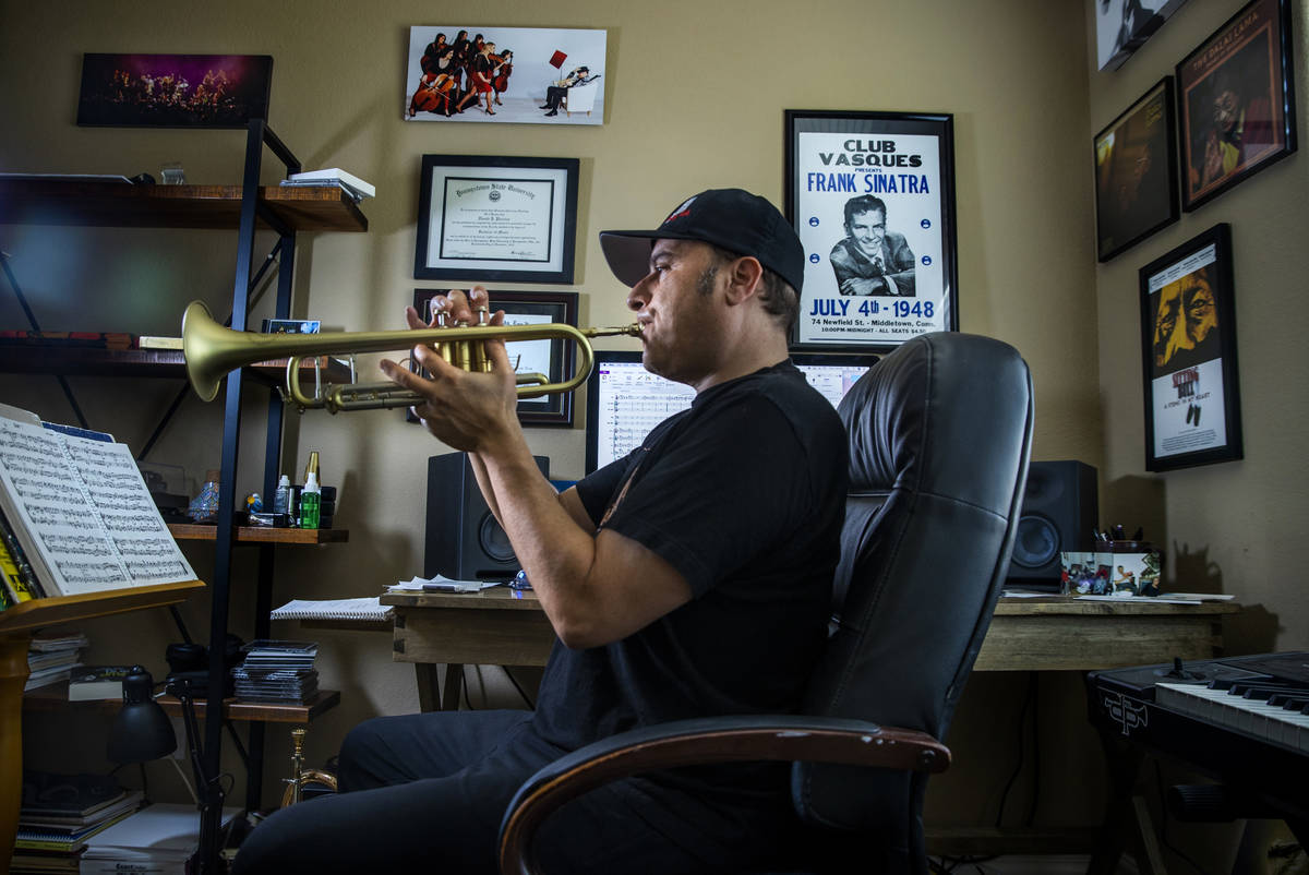 David Perrico practices at home, he a veteran trumpet player, composer and arranger and recentl ...