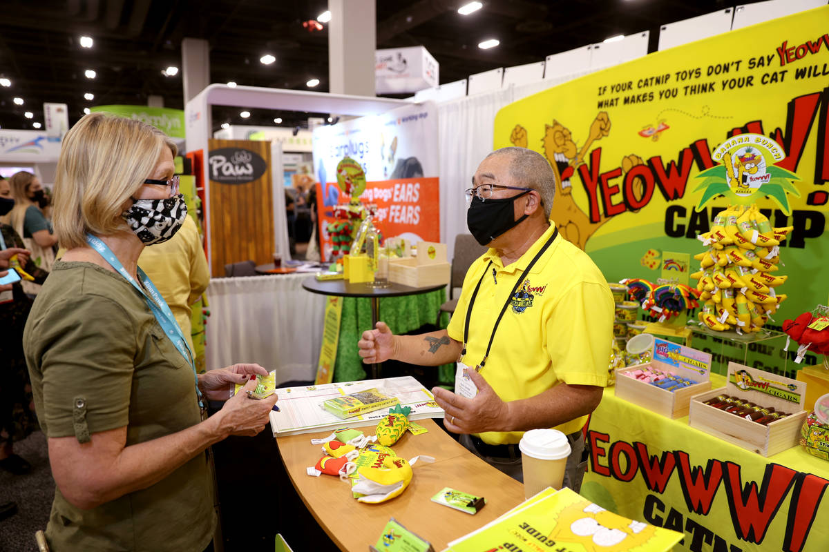 Holly Ensor of Springfield, Mo. checks out catnip products with Norm Harada with Yeowww! Catnip ...