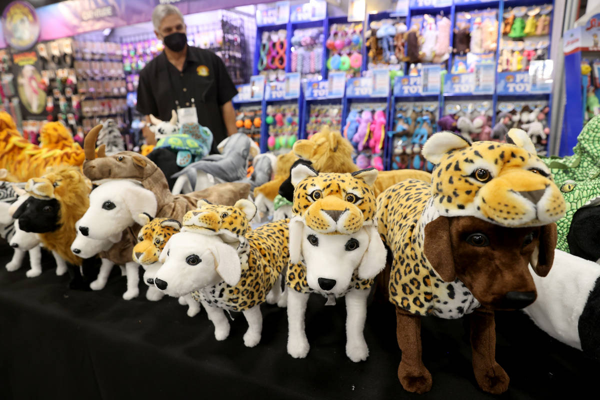 Dog costumes are shown at the Amazing Pet Products booth during the SuperZoo pet industry trade ...