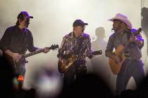 Garth Brooks performs with his band mates before the crowd at Allegiant Stadium on Friday, July ...