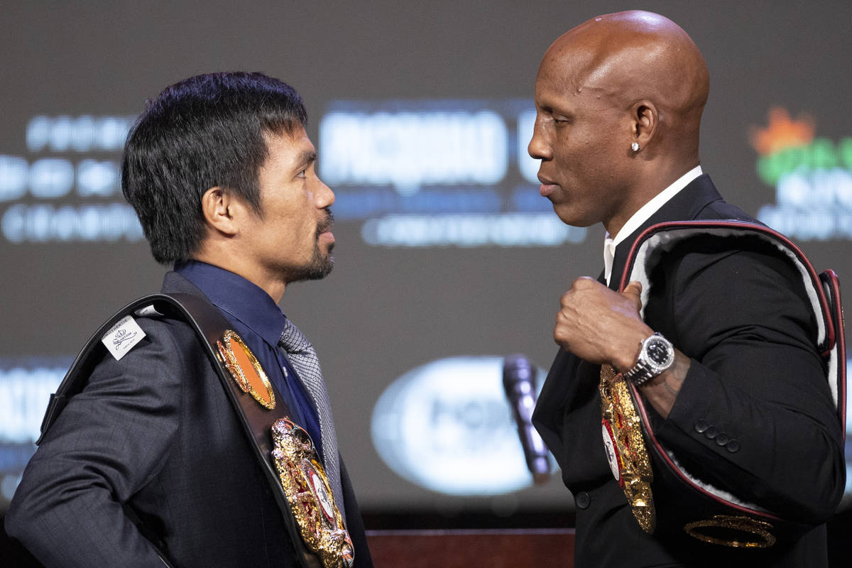 Manny Pacquiao, left, and Yordenis Ugas, face off during a press conference at the MGM Grand Ga ...