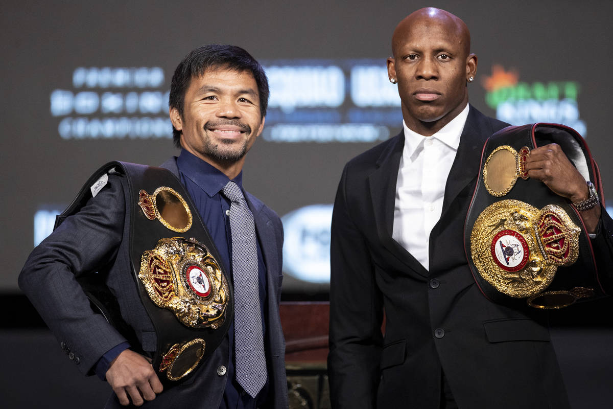 Manny Pacquiao, left, and Yordenis Ugas, pose during a press conference at the MGM Grand Garden ...