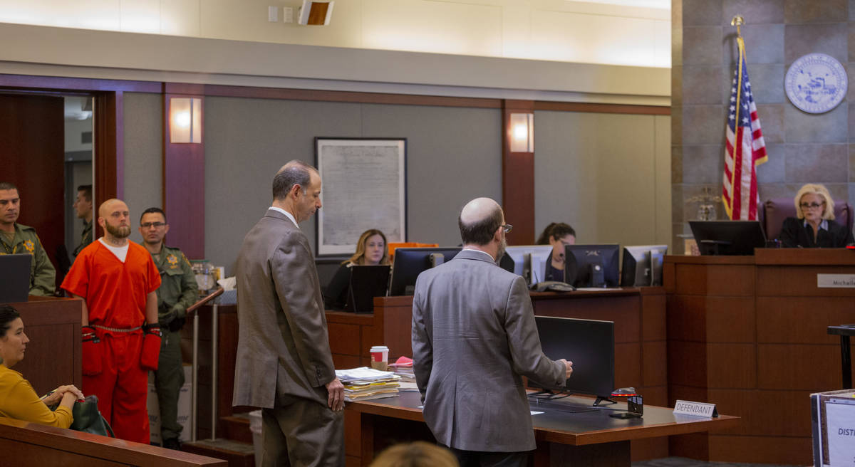 Defense attorneys Dan Bunin, left, and Dayvid Figler speak with District Judge Michelle Leavitt ...