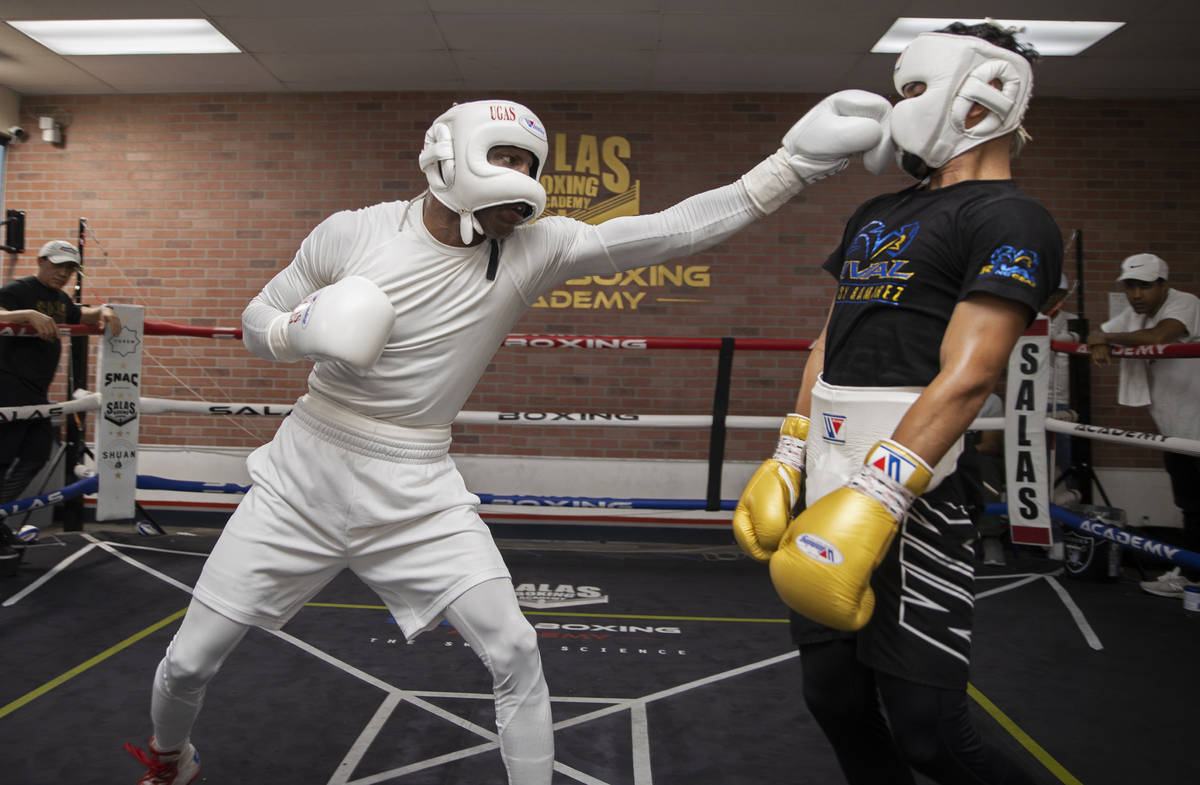 Welterweight Yordenis Ugas, left, trains for his upcoming fight with Manny Pacquiao on Monday, ...