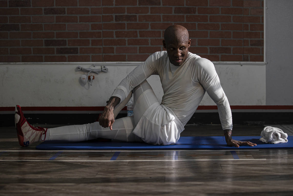 Welterweight Yordenis Ugas stretches after a training session for his upcoming fight with Manny ...