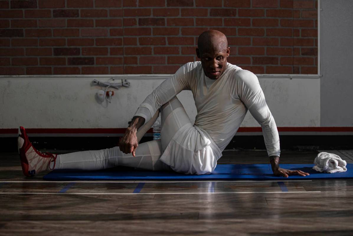 Welterweight Yordenis Ugas stretches after a training session for his upcoming fight with Manny ...