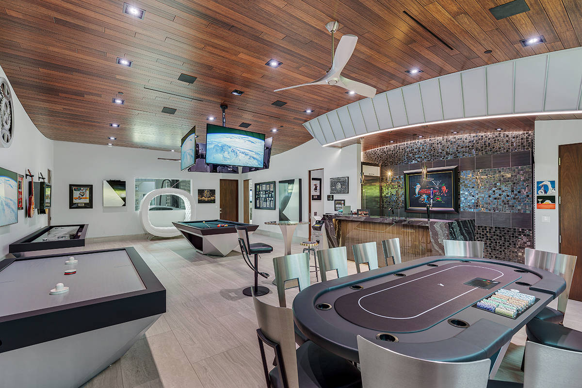 The mansion features a casino-inspired man cave with a wet bar, pool table, Texas Hold’em tab ...
