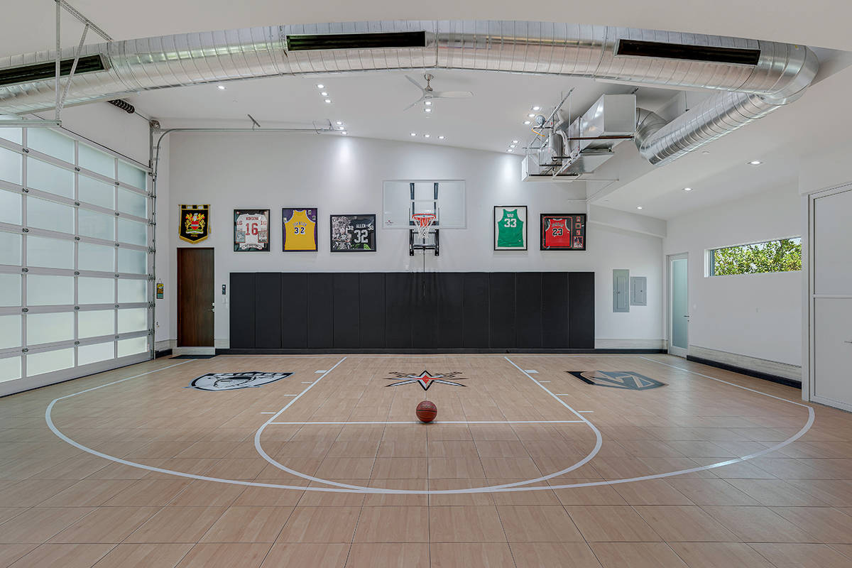 One of the home's three garages serves as a heated and cooled half-court basketball court. (The ...
