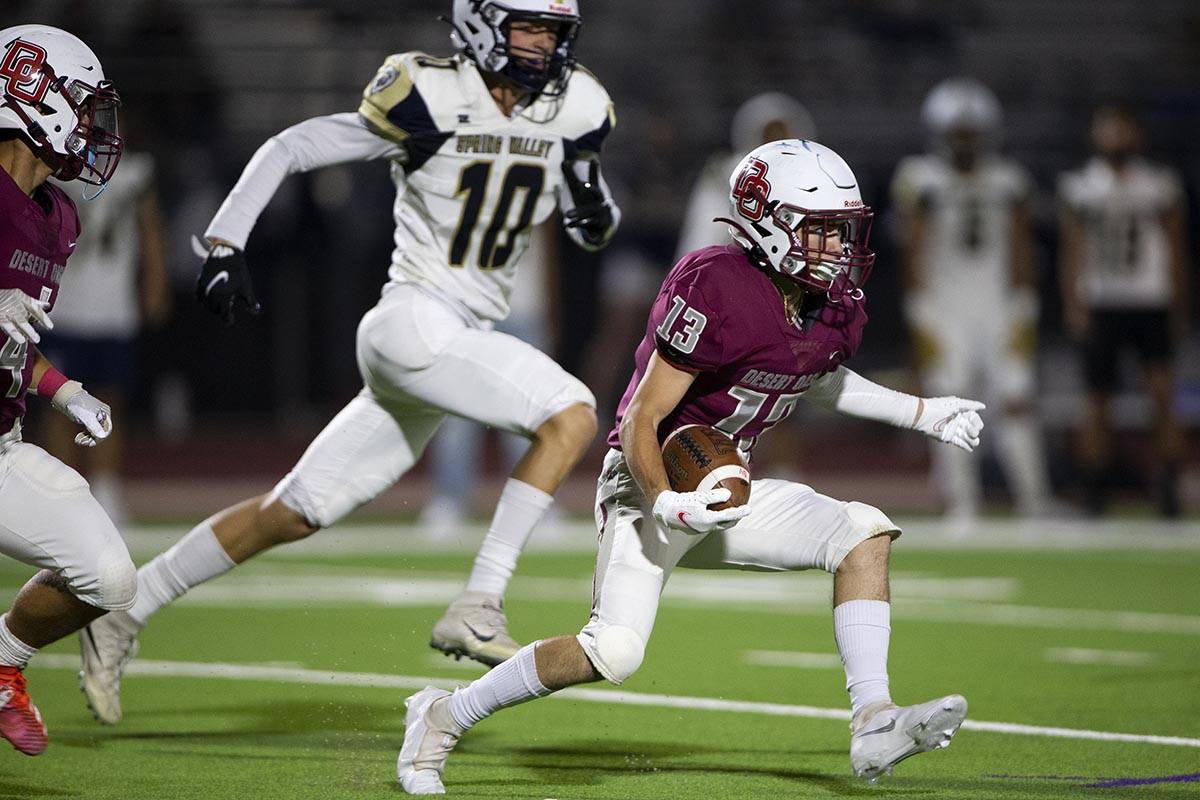 Desert Oasis wide receiver Jayce Phillips (13) breaks away followed by Spring Valley linebacker ...