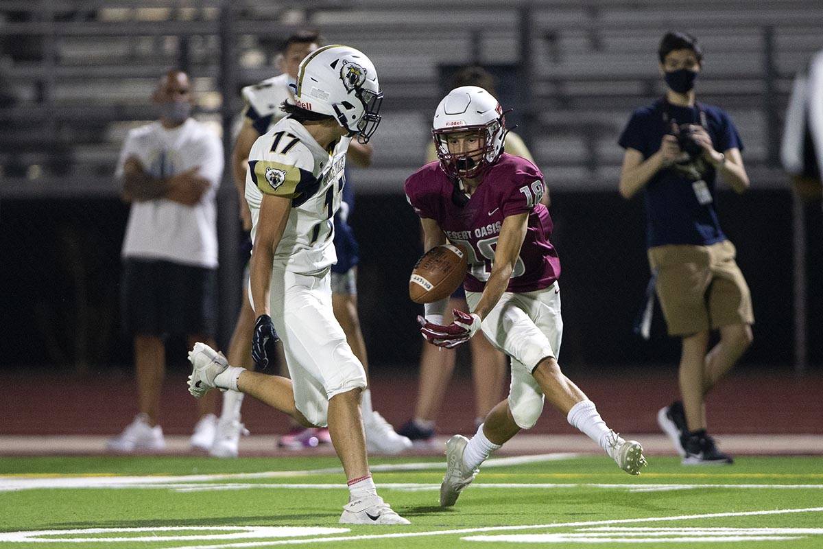 Desert Oasis wide receiver Avery Ariaga (18) attempts to catch a pass as Spring Valley defensiv ...