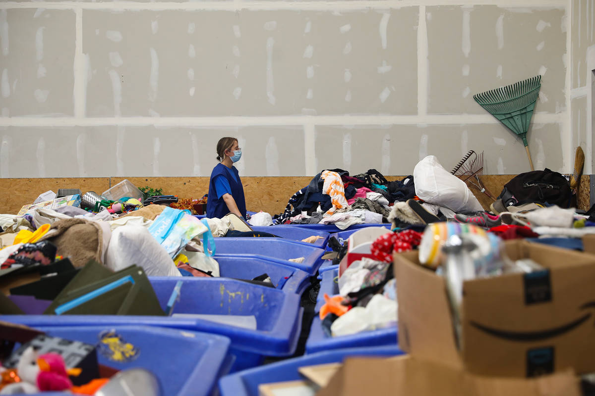 A worker moves clothes to the store from the warehouse at the Goodwill Clearance Center in Las ...