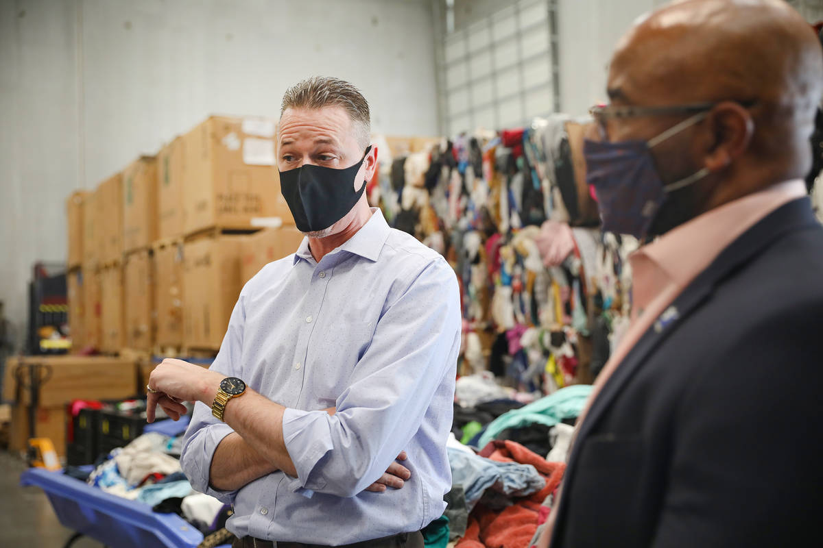 Bryce Cardin, director of operations, left, speaks to the Review-Journal next to CEO of Goodwil ...
