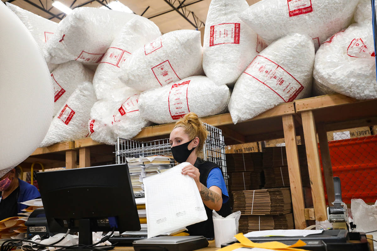 Ashley Jeffries, e-commerce lead, packs items to ship in the e-commerce area at the warehouse a ...
