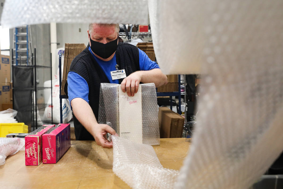 Michael Haberland, e-commerce assistant manager, packs items to ship in the e-commerce area at ...