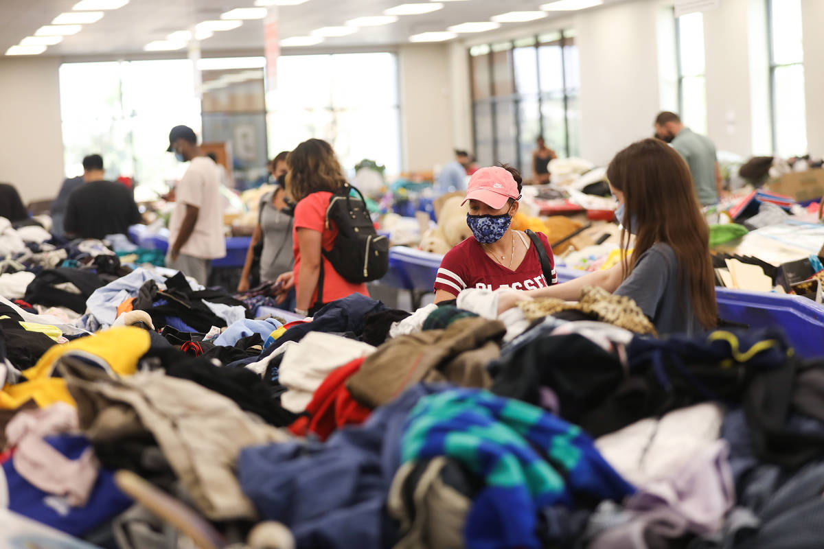 Shoppers dig through items in the thrift store portion of the Goodwill Clearance Center in Las ...