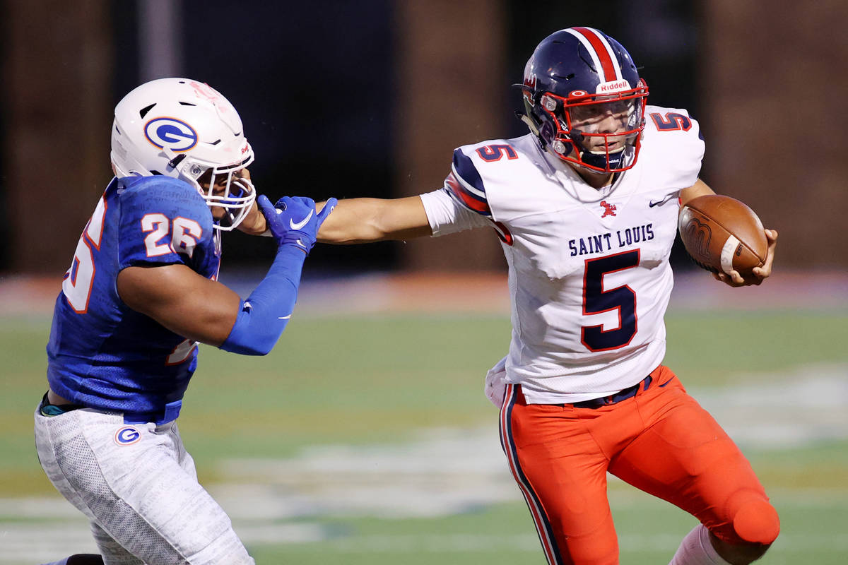 St. Louis Kaiwi Batoon (5) runs the ball under pressure from Bishop Gorman's Jamih Otis (26) du ...