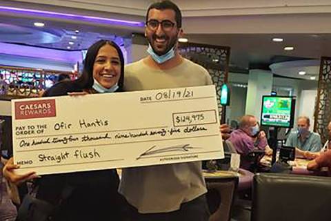 Ofir Hantis, right, poses after winning a $124,975 jackpot at Harrah's on Thursday, Aug 19, 202 ...