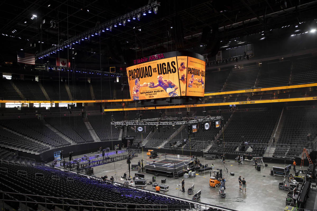 Crews set up the boxing ring for the upcoming boxing main event between Manny Pacquiao and Yord ...