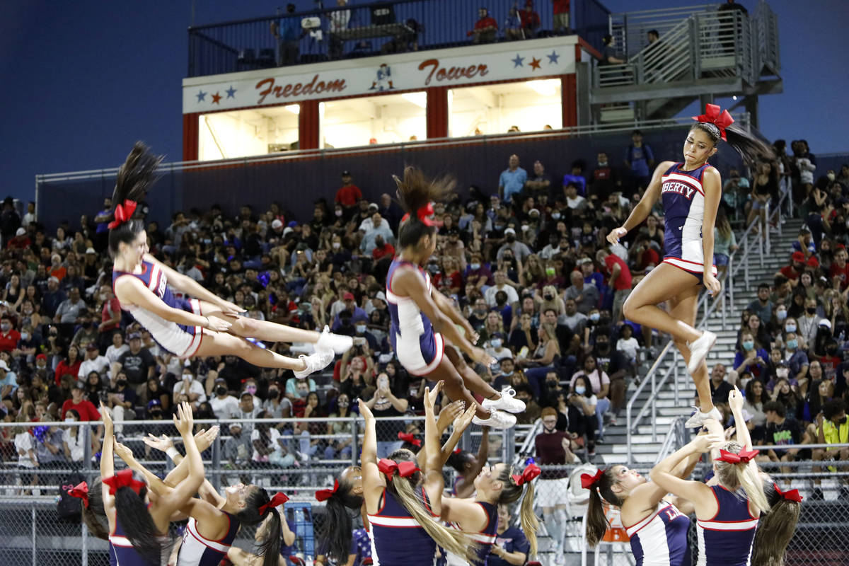 Liberty High School cheerleaders perform during the first half of a football game against Arbor ...